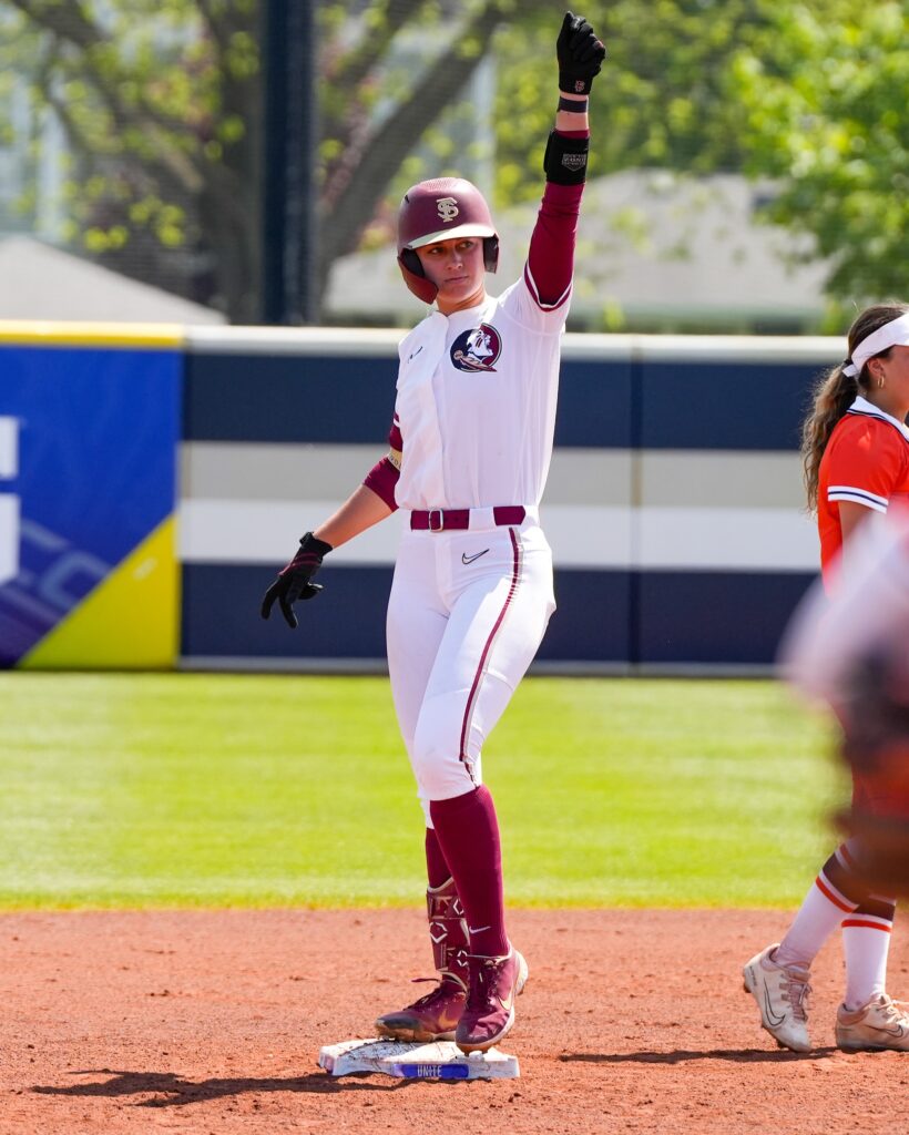 softball players try to recieve the ball
